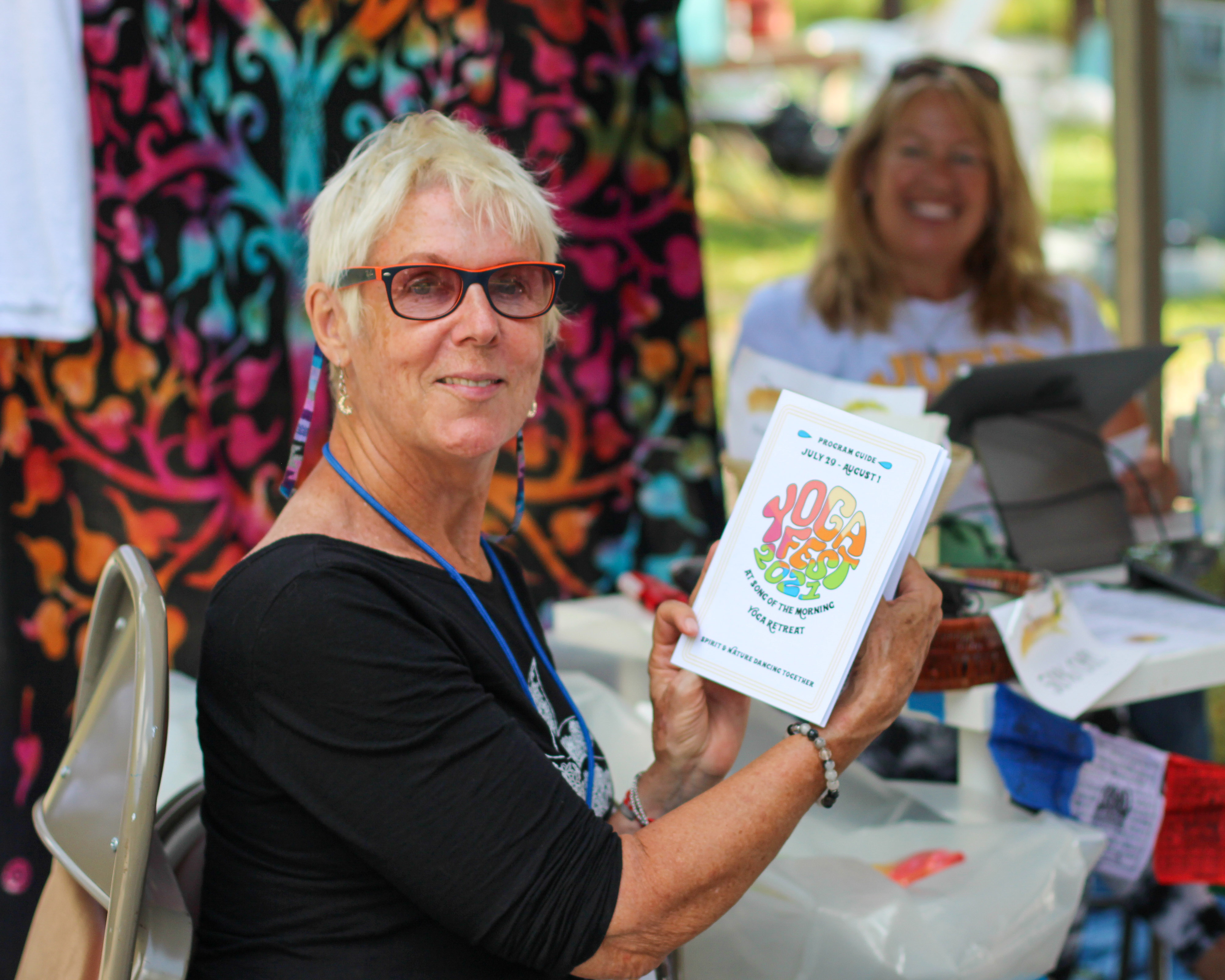 Photo of person holding printed program guide at YogaFest 2021